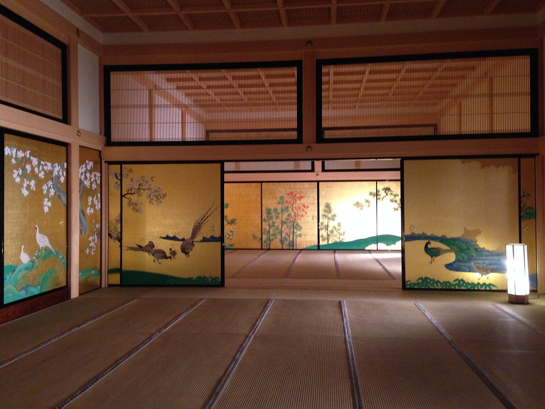 Interior of the reconstructed Hommaru Palace with gold-leaf painted sliding doors and tatami